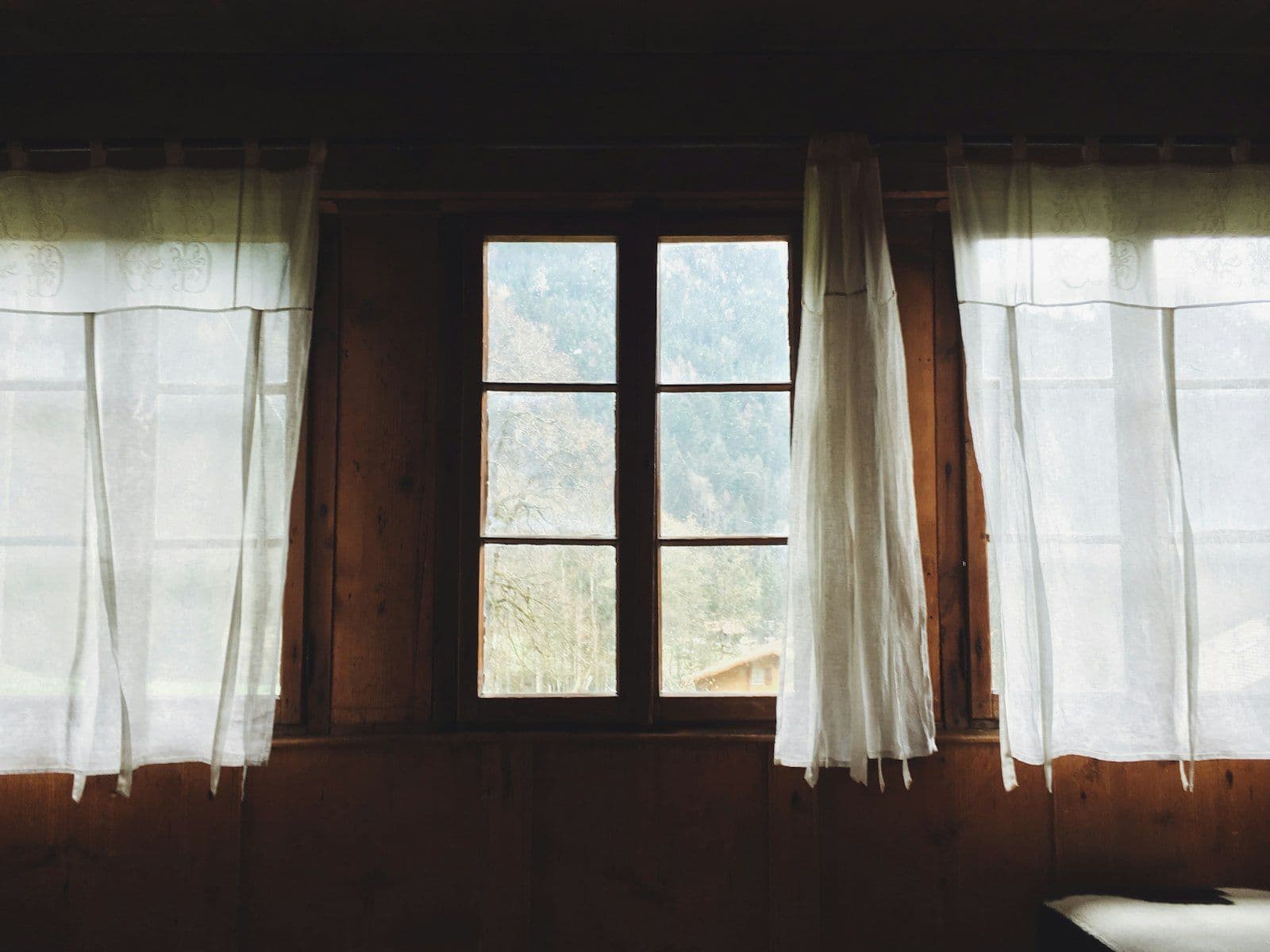 Warm light falling through a thin curtain