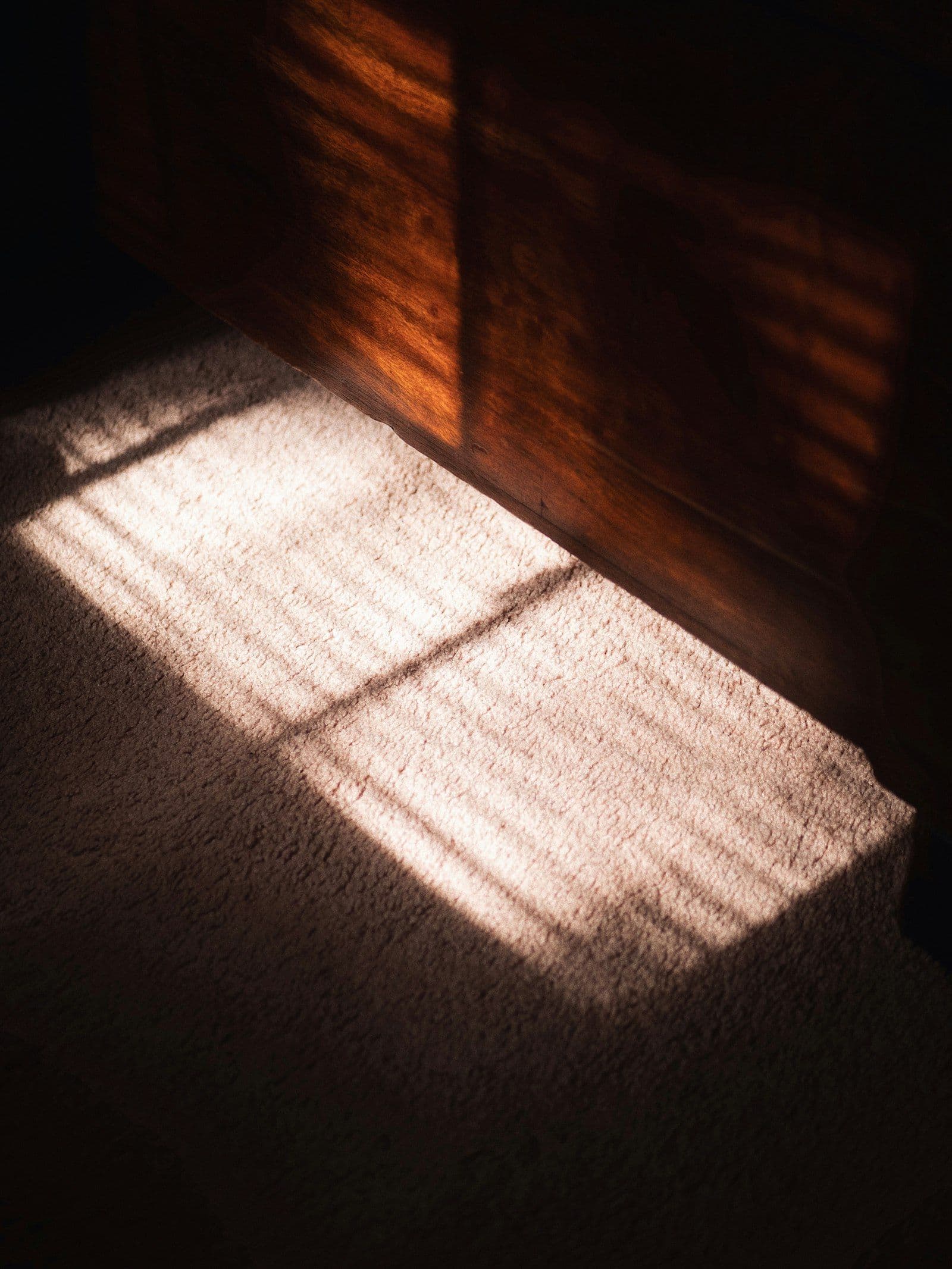 Morning sun laid in bright bars across a wooden floor