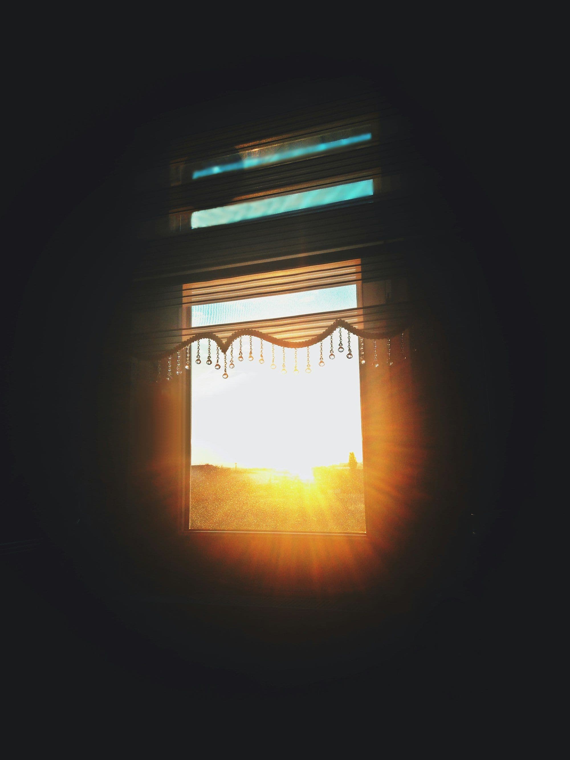 Sunlight slatted across a wall through half-open blinds